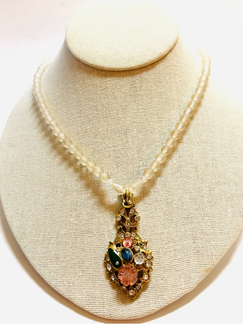 1928 Gold-Tone Pendant Necklace with Green, Blue, Pink, and Clear Stones